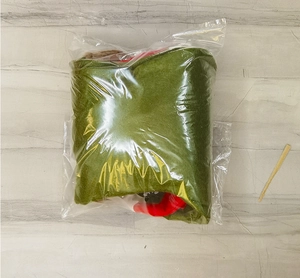Green felt Christmas stocking detail packed in a clear protective plastic bag