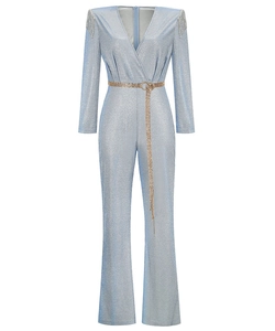 Detail of light blue sequined romper with deep V-neck, silver fringes, and metal chain belt