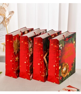 Close-up of extra-large Christmas gift bags with gold foil and festive patterns