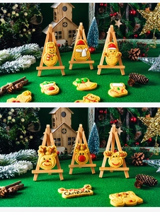 Detail of Christmas themed sugar cookies in snowman and reindeer shapes on festive decor
