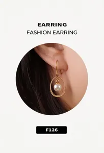Close-up of a minimalist 18k gold hoop earring with a single round white pearl