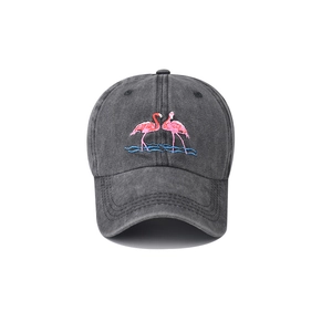 Detail of pink flamingo embroidery on washed cotton fabric of the vintage baseball cap