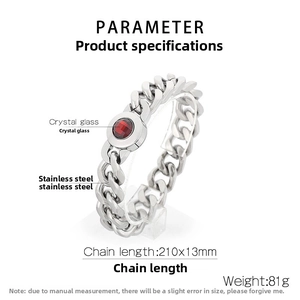 Detail showing 13mm silver stainless steel Cuban link chain with round red crystal glass