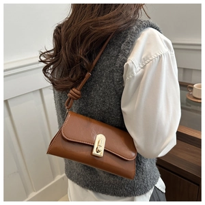 Brown vintage flap shoulder bag with gold metal twist lock and decorative knot strap