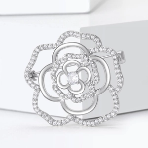 Luxury silver camellia flower brooch with hollow petals and micro-set cubic zirconia stones