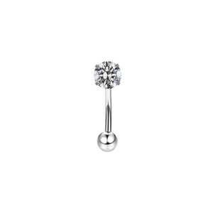 Macro shot of curved stainless steel eyebrow piercing with clear cubic zirconia stone
