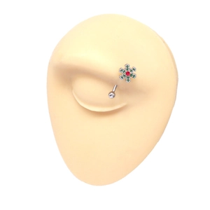 Detail of stainless steel eyebrow ring with snowflake design and red rhinestone insert