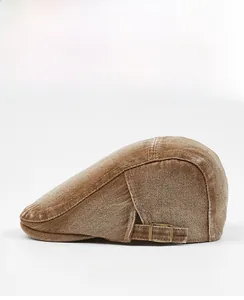 Side view of brown washed cotton flat cap featuring vintage texture and metal side buckle