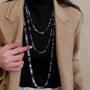 Detail of colorful faceted crystal beads on a layered bohemian necklace for women