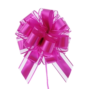 Macro view of rose red ribbon pull bow with sheer organza and satin layers