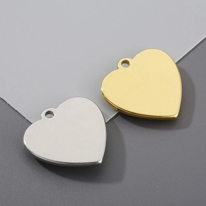 Macro shot of 3D heart-shaped stainless steel pendants in gold and silver finish