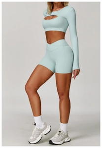 Detail of light blue yoga set with cutout crop top and V-waistband fitness shorts