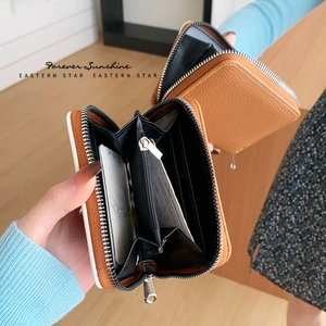Brown accordion zip-around leather wallet with multiple card slots and coin pocket