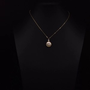 Elegant gold chain necklace with a baroque freshwater pearl pendant on a black bust display