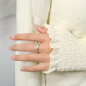 Detail view of silver crab ring with marquise cut crystal on model's finger