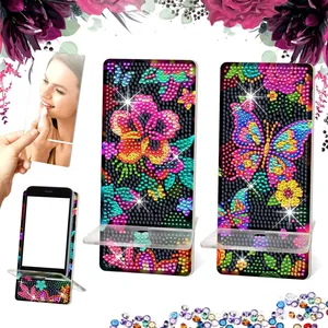 Close-up of DIY diamond painting phone stand with colorful floral and butterfly patterns