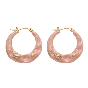Golden irregular geometric hoop earrings with pink resin finish and tiny crystals