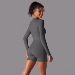 Dark gray long sleeve zip athletic romper with slim fit silhouette for yoga or fitness