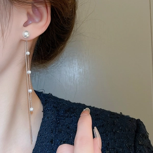 Elegant silver pearl tassel earrings with long fringe chains for women on model