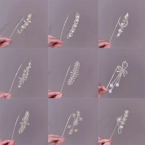 Golden princess style headband collection with pearls and rhinestones on beige background