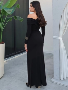 Slim fit black off-shoulder knit maxi dress with gold ring details on sleeves