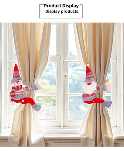 Close-up of Santa and Snowman plush curtain tiebacks in a festive window setting