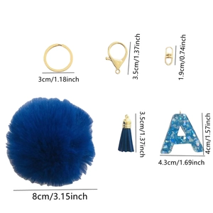 Detail of blue pompom keychain showing sizing of the glitter letter A and plush ball
