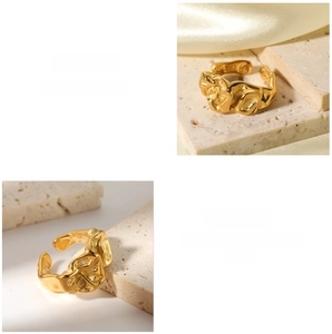 Detailed macro shot of a gold lava-textured titanium ring on silk and stone surfaces