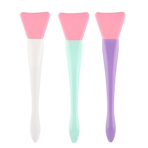 Detailed view of silicone face mask brushes with flexible pink tips and colored handles