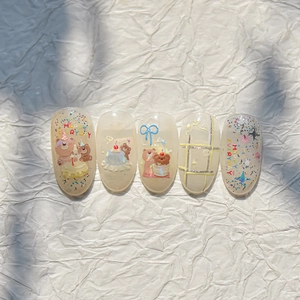 Detail of Korean style bear and cake embossed nail stickers on translucent beige base