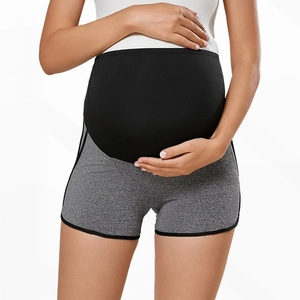 Detailed view of high-waist support band on gray maternity athletic shorts