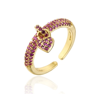 Macro detail of 18K gold heart ring with pavé purple zircon and open design style