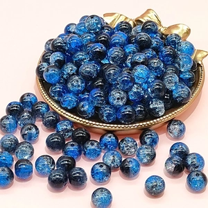 Blue 10mm cracked glass beads for DIY jewelry making displayed on a gold tray