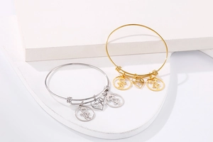 Adjustable stainless steel bangles with boy, girl, and heart charms on white stone