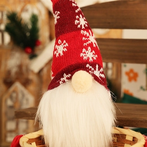 Close-up of Christmas gnome candy basket with red snowflake hat and bamboo weave detail