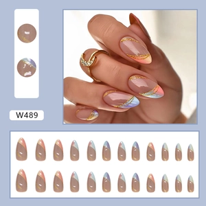 Almond shaped press-on nails featuring a colorful gradient with gold glitter line accents