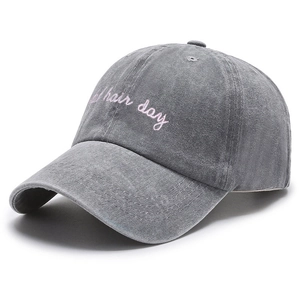 Washed grey cotton baseball cap with pink bad hair day embroidery on white background