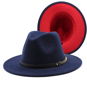 Detailed view of bicolor wool fedora with red underside and golden chain embellishment