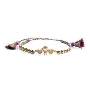 Detail of woven adjustable bracelet featuring gold-plated boy and double heart charms
