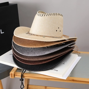 Detail of straw cowboy hats with metal star chains and hollow weave texture