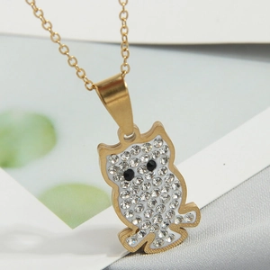 Macro shot of owl pendant necklace with gold plating and shimmering pavé crystals