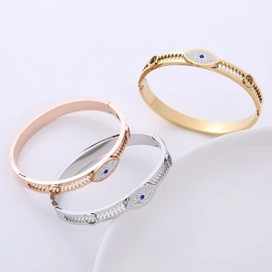 Evil eye bangle set in gold, rose gold and silver finishes with gear hollowed frame