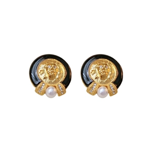 Vintage lion head earrings with black enamel and white pearl drop on white background