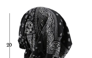 Detail view of black paisley turban hat with 20cm measurement showing elastic fit
