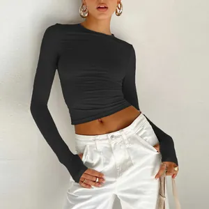 Detail view of the functional thumbholes on black slim fit long sleeve crop top