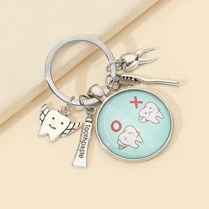 Creative silver alloy dental keychain with tooth, toothbrush, and toothpaste charms