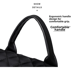 Detail view of the comfortable black leather top handle and quilted nylon backpack surface