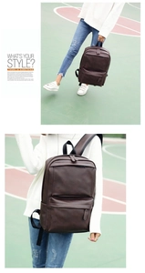 Detail view of dark brown PU leather backpack showing dual zippers and sturdy top handle