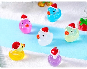 Close-up of colorful miniature resin ducks wearing festive red and white Christmas hats