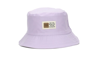 Detailed view of lavender purple bucket hat featuring decorative beige fabric patch